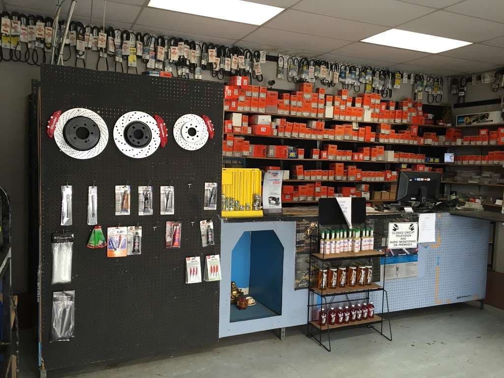 ACR Auto Parts counter area with brake rotor display and stocked shelves